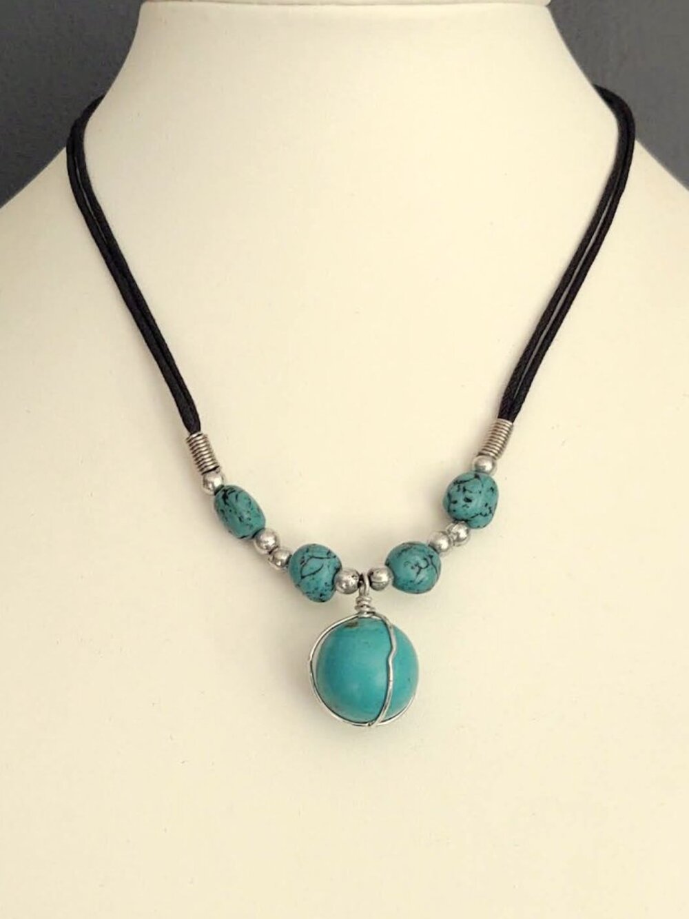 Turquoise and silver necklace on black cording